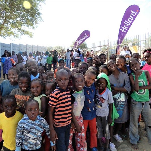 Community of children gathered together, posing for the camera