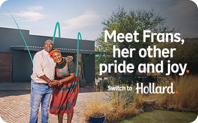 Hollard Building Insurance customer standing in front of her insured house, hugging her husband